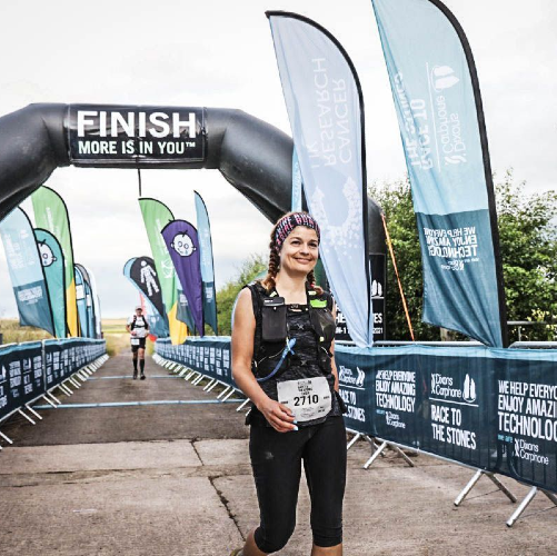 lydia dakin at finish line of ultramarathon