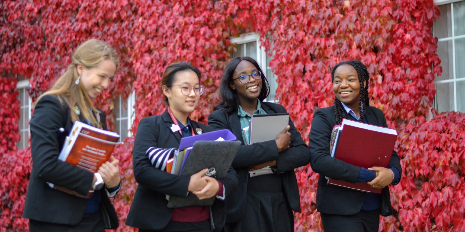 Downe House girls with leaf backdrop
