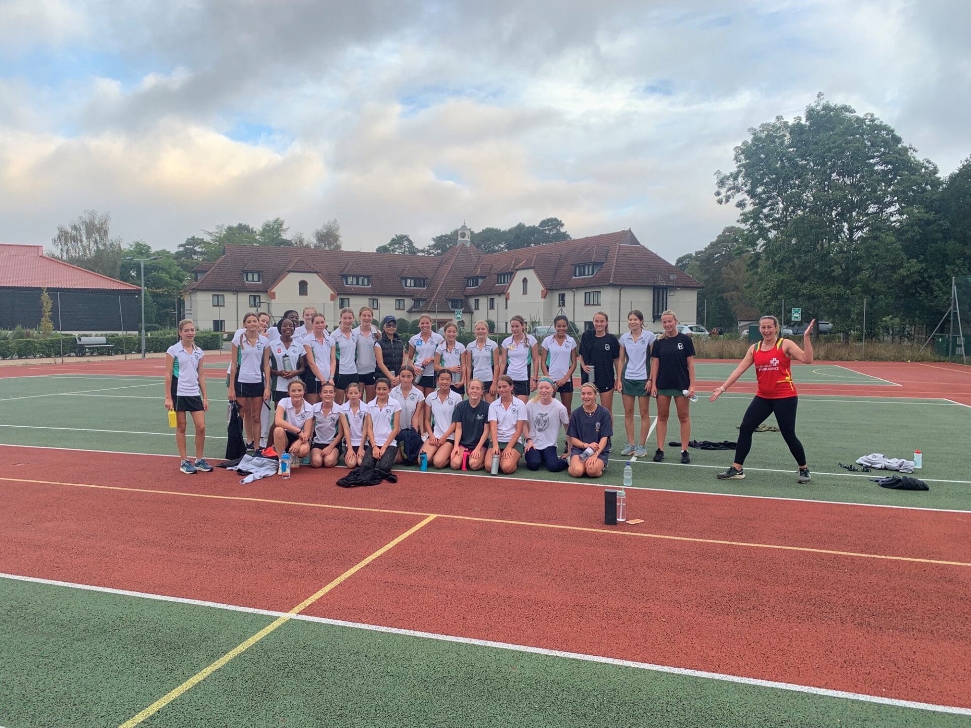 Miss Quarterman with girls training on tennis courts