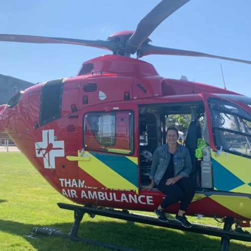 Miss Quartermann sits in the doorway of a Thames Valley Air Ambulance