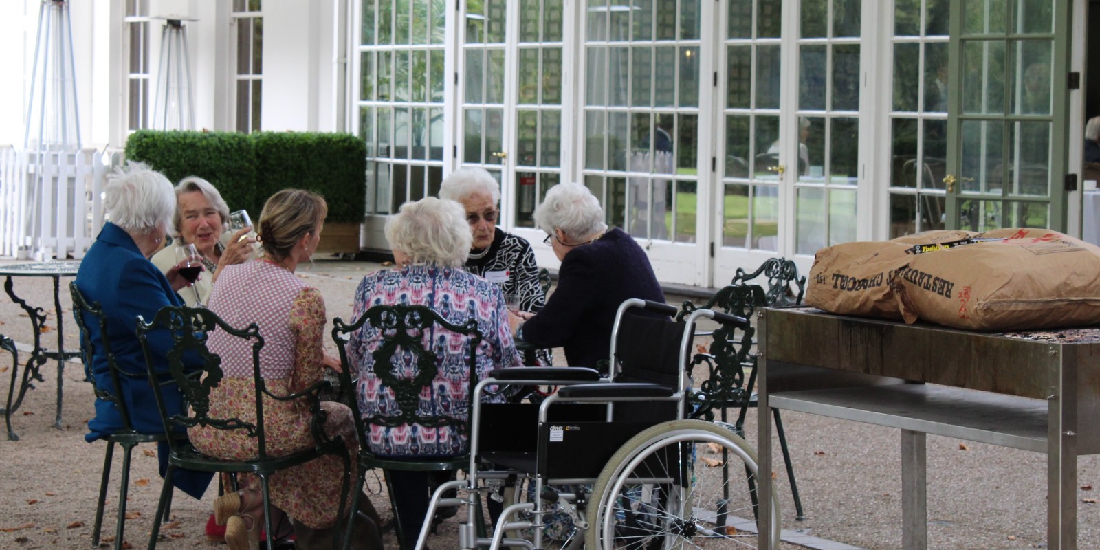 Downe House Seniors chat at Hurlingham Club table outside
