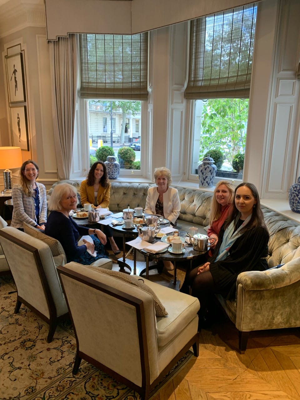 Staff members sit and have afternoon tea together