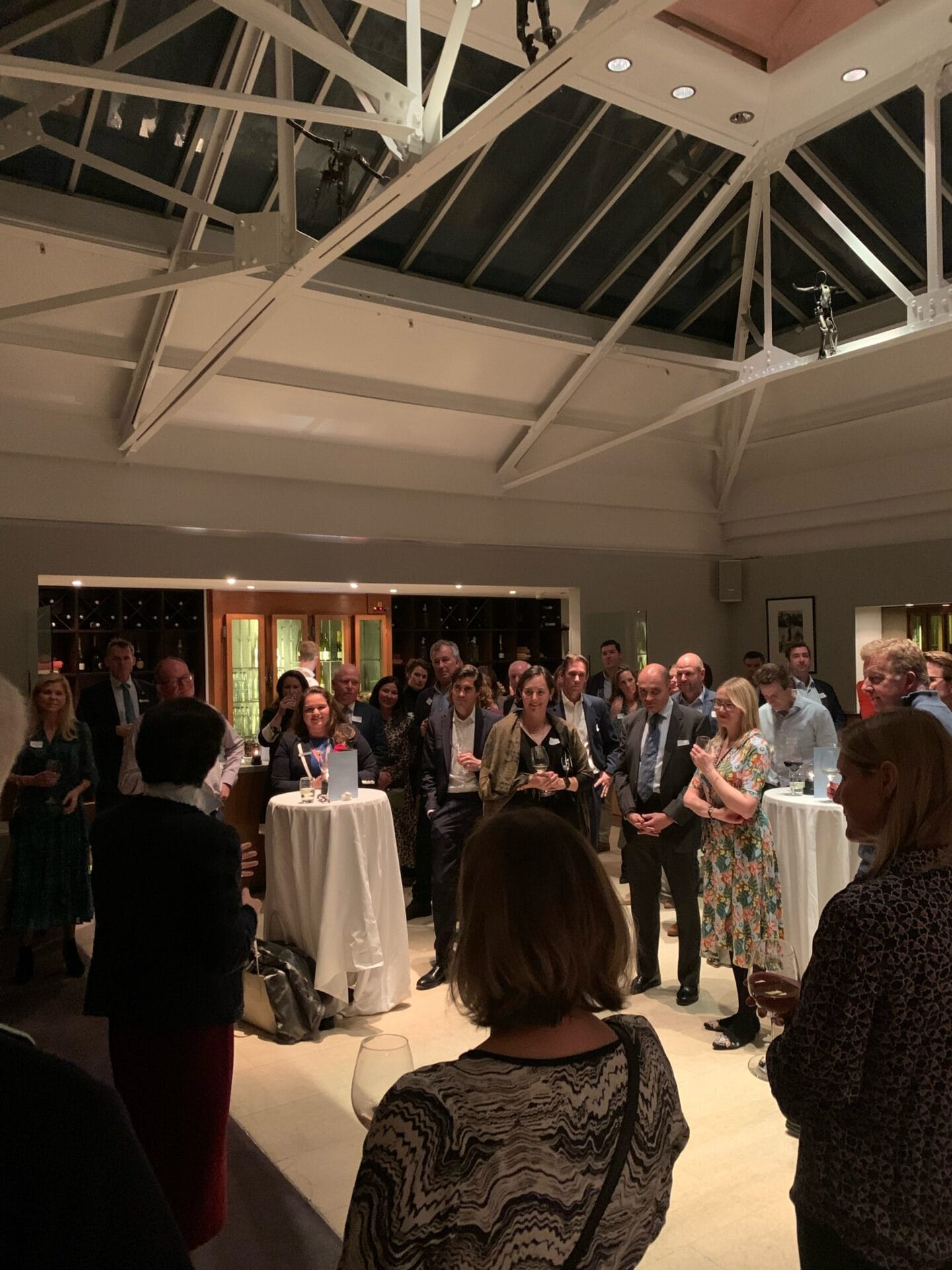 Parents gather at the Bluebird Cafe to listen to speech during drinks reception